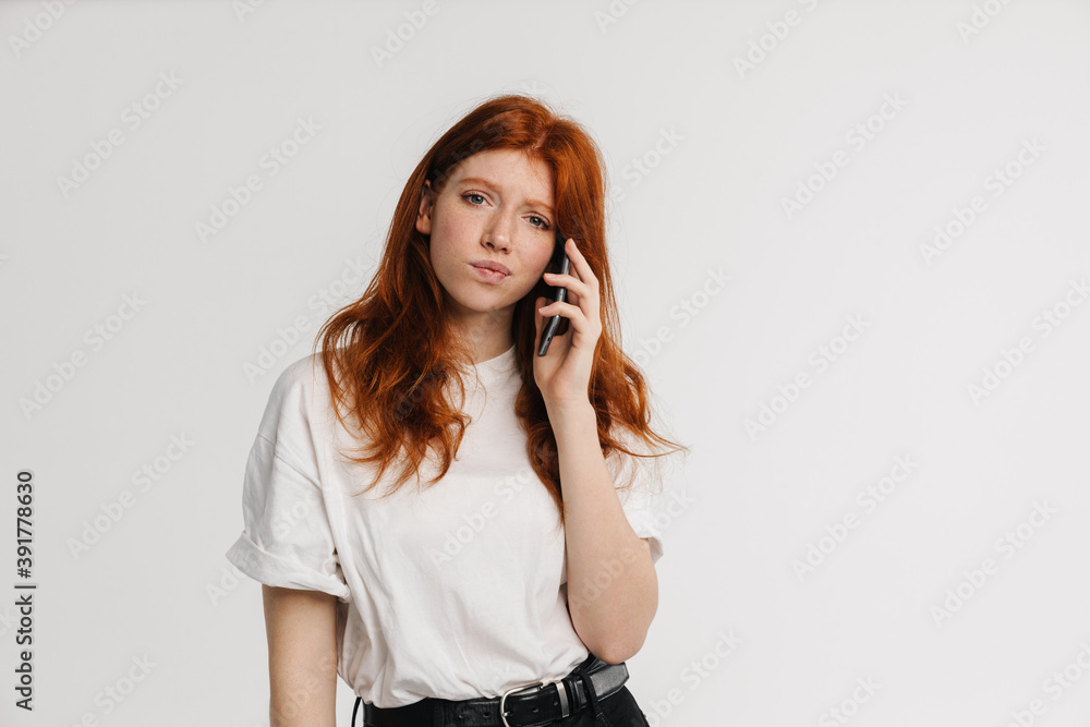 Ginger beautiful confused girl talking on cellphone Ginger beautiful confused girl talking on cellphone