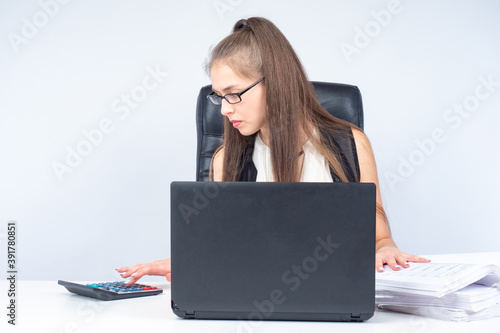 Girl works with a laptop an...