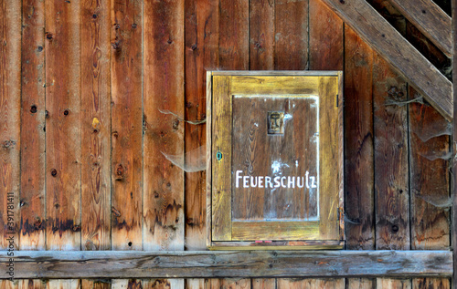 Wooden fire protection casing in an old barn with cobwebs in Tirol, Austria photo