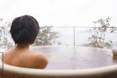 Japanese woman taking outdoor bath 