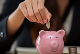 Close up female hand putting coin in piggy bank. Save money,household payments, utility bills, calculating,monthly family,Finance or Savings concept.
