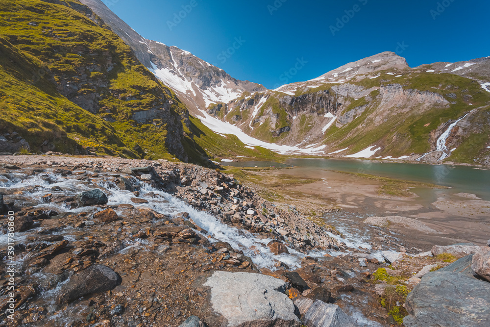 High mountains with water, melting in summer Alps, Austria