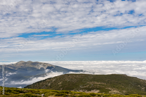 Beautiful sea of clouds from a mountain on a sunny day. Low clouds in the Sierra de Guadarrama, Madrid.