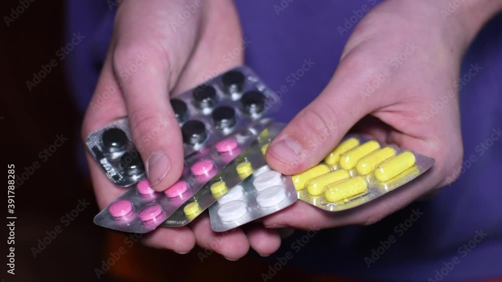 a man is holding colorful pills. (capsule pills). medicine for the treatment of bacterial and viral diseases. a man is holding colorful pills. (capsule pills). medicine for the treatment of bacterial and viral diseases.
