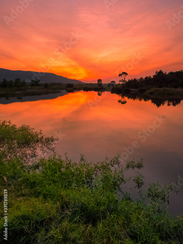 sunset with red sky in the mountains over the lake