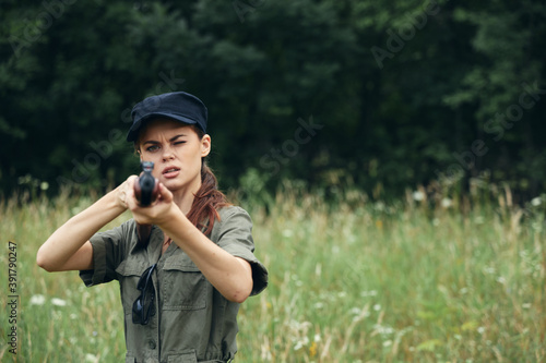 Woman soldier The hunting sight is holding a gun in front of him black cap  © SHOTPRIME STUDIO