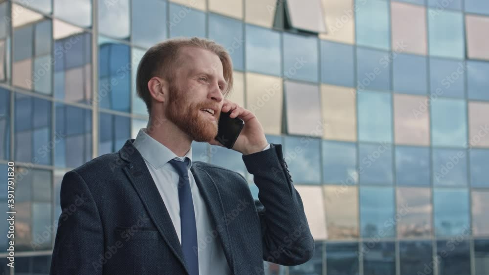 Middle age Attractive Businessman Using Smartphone and Speaking with his Investors. Man with Beard standing on the balcony during of city center the break. Wearing stylish Formal Coat Slow Motion 4K Middle age Attractive Businessman Using Smartphone and Speaking with his Investors. Man with Beard standing on the balcony during of city center the break. Wearing stylish Formal Coat Slow Motion 4K