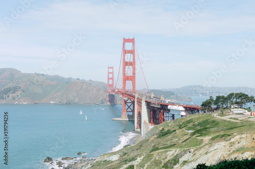 Photography Golden gate bridge over water from park with sailboats