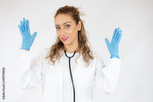 Beautiful doctor woman wearing stethoscope and gloves over isolated white background smiling confident.