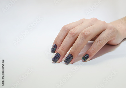 Stylish fashionable female manicure. Beautiful hand of a young woman on a white background. Close-up. Copy space.
