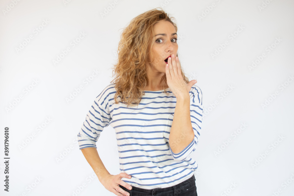 Beautiful woman with facial expression of surprise wearing casual striped t-shirt standing over white background. Beautiful woman with facial expression of surprise wearing casual striped t-shirt standing over white background.