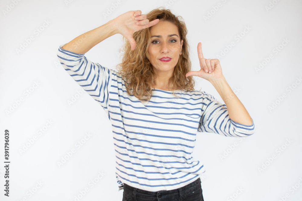 Happy woman making frame with fingers isolated on a white background Happy woman making frame with fingers isolated on a white background