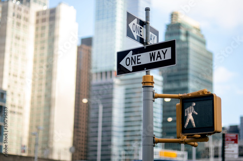 One way road sign (pedestrian signal) and traffic light in NYC