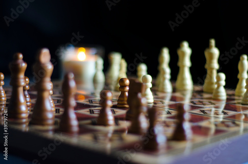 Wallpaper Mural Chess board with figures on a dark background and with candles in the background. Confrontation concept, intellectual long game. Beautiful smart concept. Torontodigital.ca
