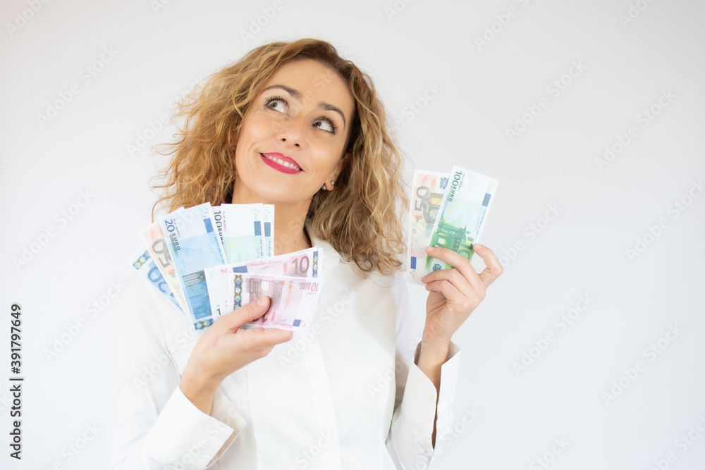 Portrait of a cheerful woman holding money banknotes isolated over white background Portrait of a cheerful woman holding money banknotes isolated over white background
