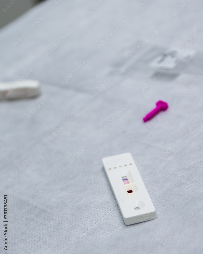 Hands of a nurse with individual protection equipment ,in the process of blood collection to make a rapid test for covid-19(coronavirus), in a hospital ward with sanitary elements. Hands of a nurse with individual protection equipment ,in the process of blood collection to make a rapid test for covid-19(coronavirus), in a hospital ward with sanitary elements.