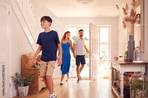 Parents With Son Looking Around New Home Before They Move In