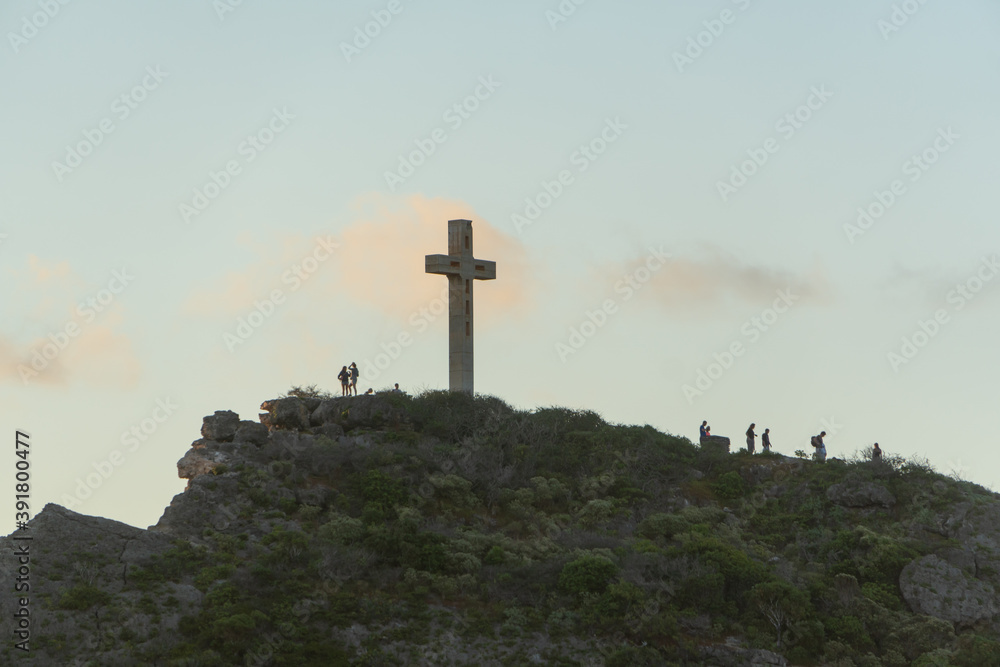 Pointe des Châteaux, Grande-Terre, Guadeloupe - March 19, 2019: Both locals and tourists hiked up to the cross to watch the sunrise over where the Caribbean Sea and Atlantic Ocean converge