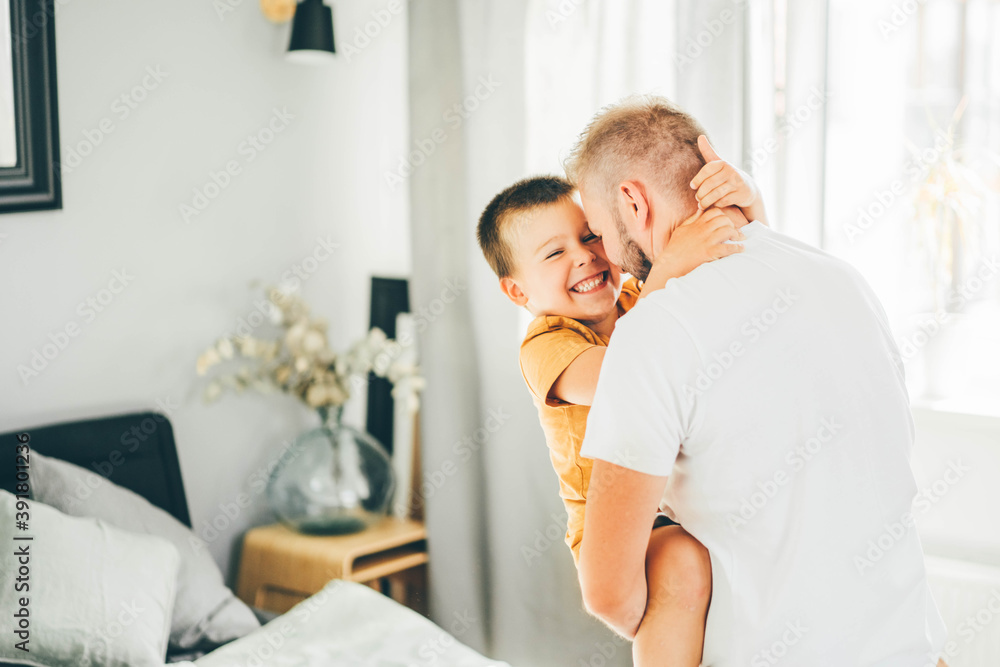 Cute daddy playing with son at Home. Father's Love, Parenting And Fatherhood Happiness Concept Cute daddy playing with son at Home. Father's Love, Parenting And Fatherhood Happiness Concept