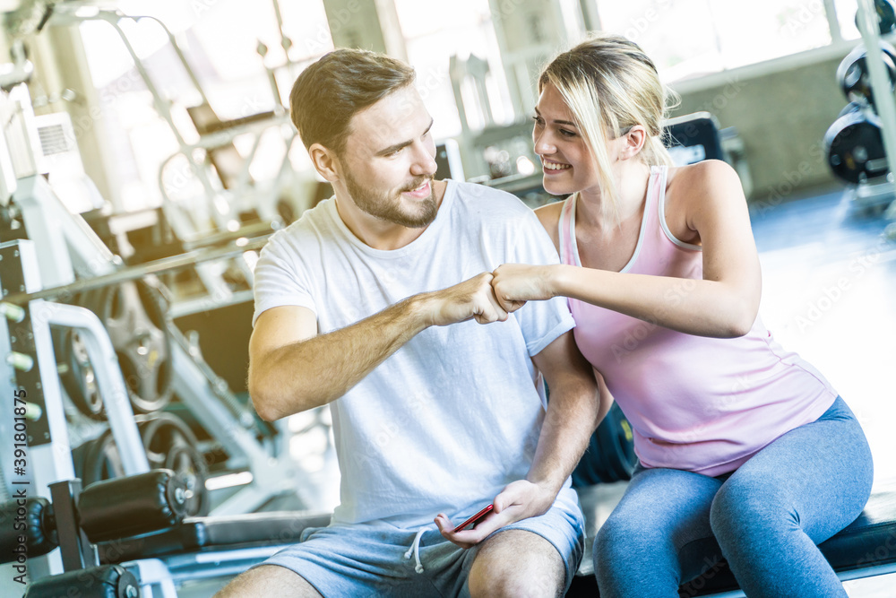 Obraz premium Portrait of couple attractive sportive giving each other fighting punch