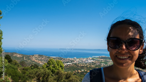 Nice girl smiling and posing in front of the Golfe of Saint Tropez
