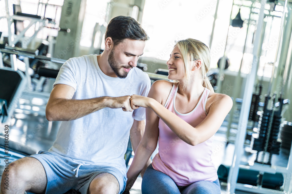 Portrait of couple attractive sportive giving each other fighting punch Portrait of couple attractive sportive giving each other fighting punch