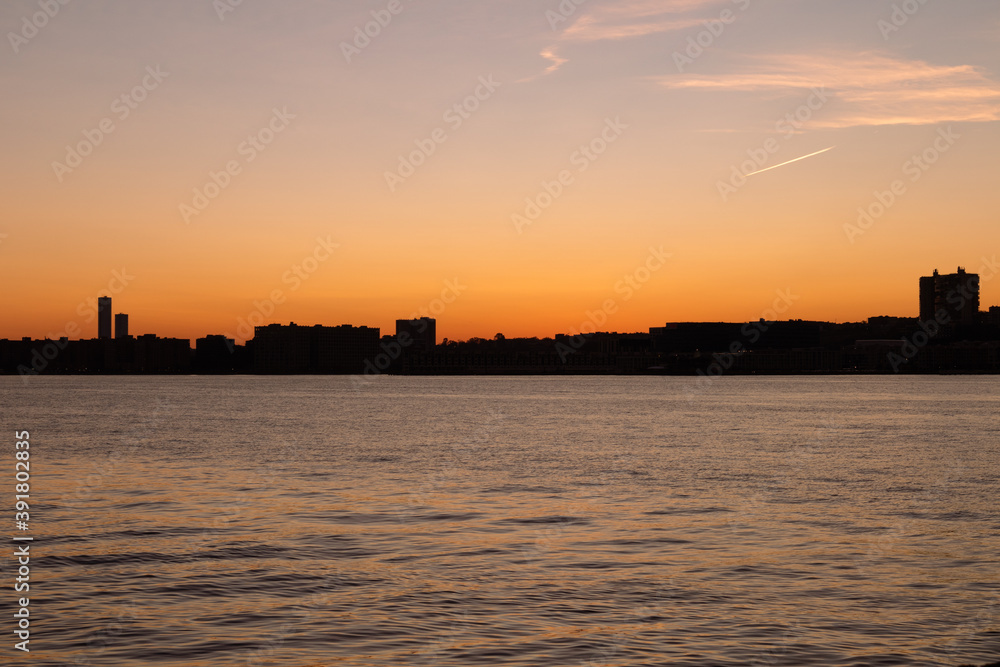 Colorful Sunset over a Silhouette of the Weehawken New Jersey Skyline along the Hudson River