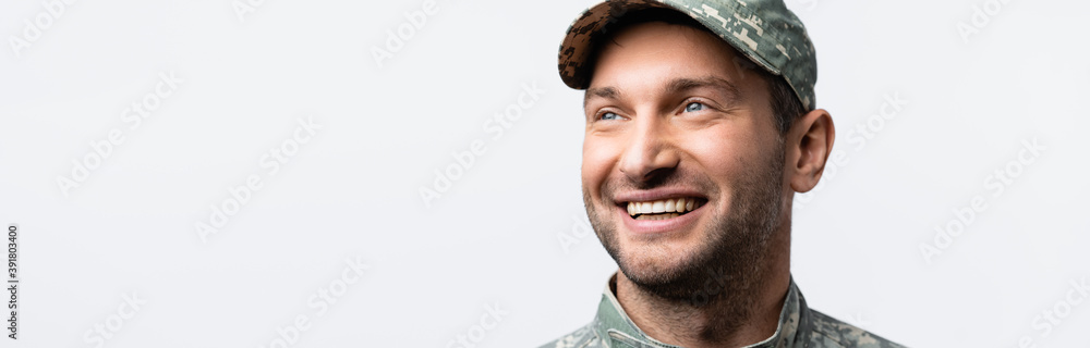 happy military man in uniform and cap looking away isolated on white, banner happy military man in uniform and cap looking away isolated on white, banner
