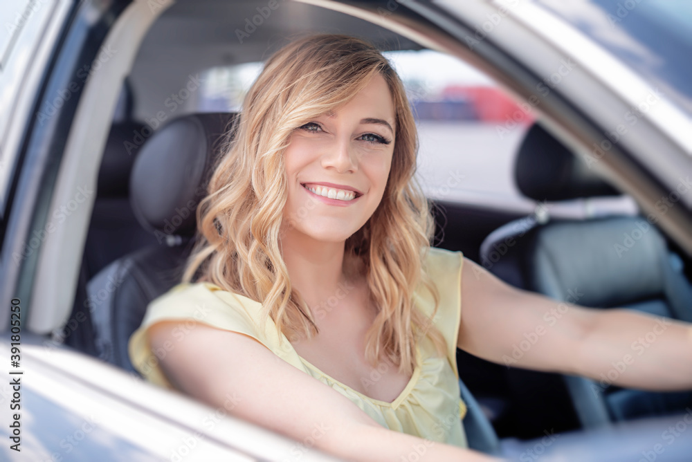 The blonde in the car. Attractive woman drives a car.