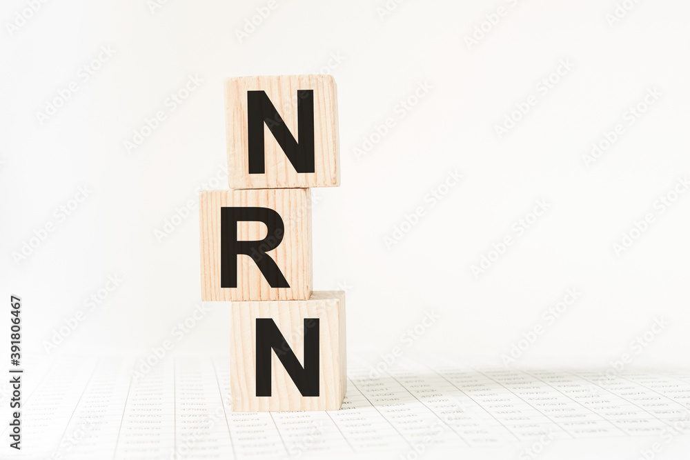 word NRN on wooden blocks, white background, business concept. business and Finance word NRN on wooden blocks, white background, business concept. business and Finance