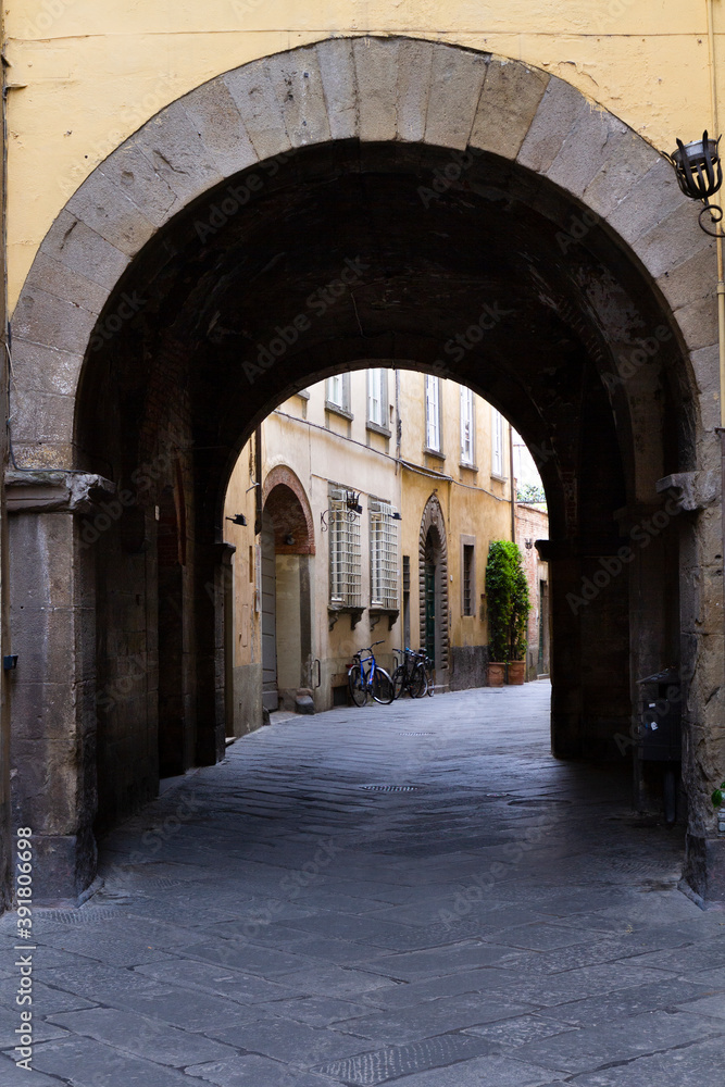 Ancient alley of Lucca with arch