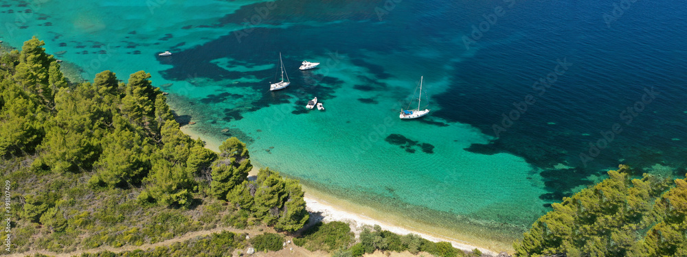 Aerial ultra wide panoramic view of tropical paradise rocky bay visited by sailboats and yachts in Caribbean exotic destination island