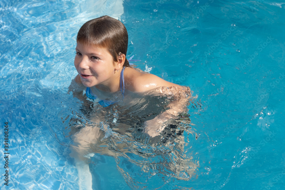 child boy stay in swimming in pool outdoor alone