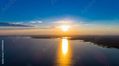 Scenic view from drone over sunset on water and coastal line © idea_studio