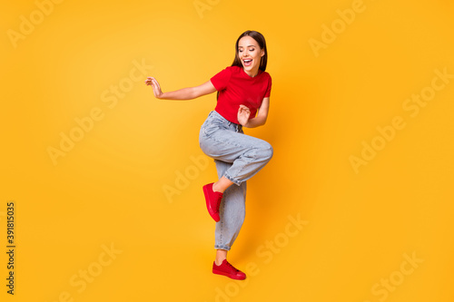 Fototapeta Naklejka Na Ścianę i Meble -  Full length photo of dancing lady at students party wear red crop top jeans shoes isolated yellow color background