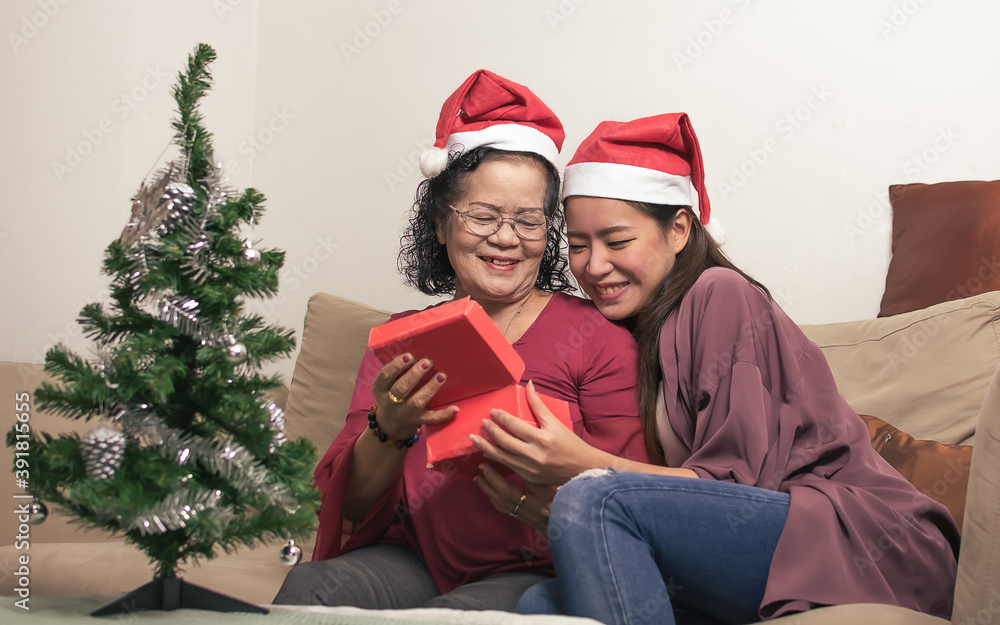 Old mother and daughter celebrate New Year or Christmas party at home Old mother and daughter celebrate New Year or Christmas party at home
