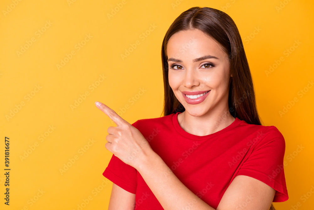 Photo of pretty lady directing index finger side empty space wear casual red top isolated over yellow color background Photo of pretty lady directing index finger side empty space wear casual red top isolated over yellow color background