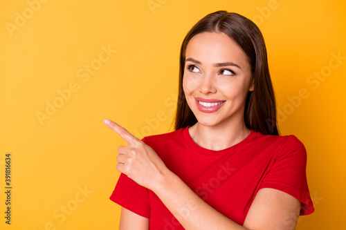 Photo of pretty interested lady direct index finger side empty space wear casual red top isolated over yellow color background
