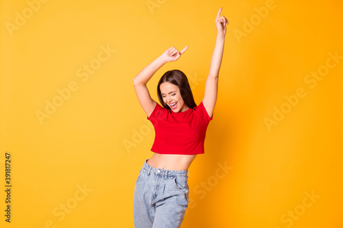 Tela Charming lady having fun raise hands moving dance floor wear red crop top jeans