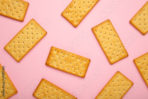 Cracker on pink background with copy space.