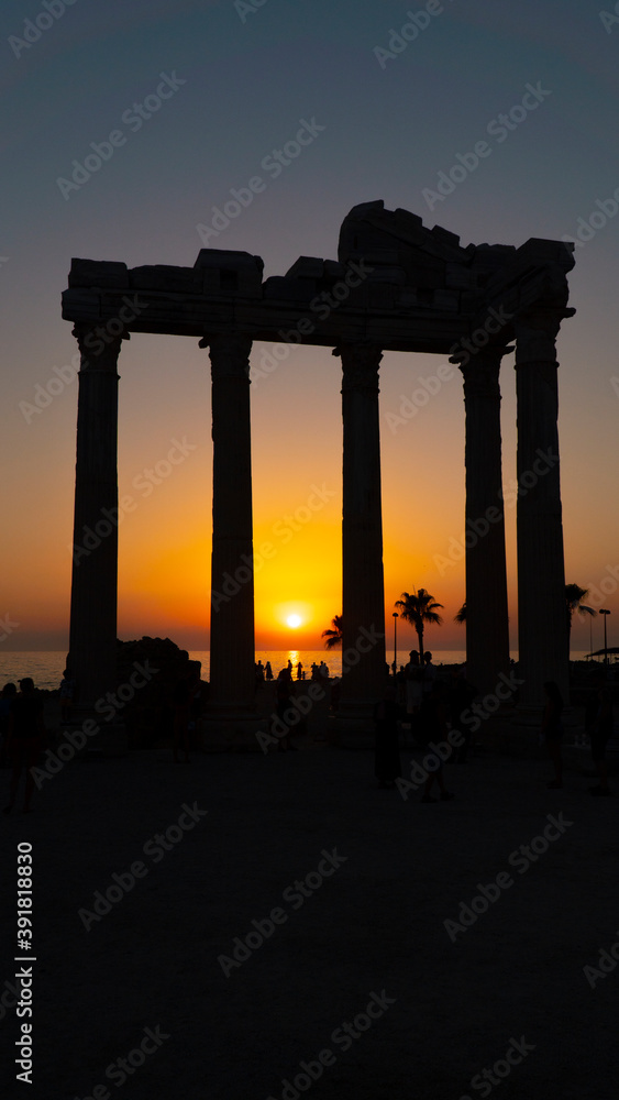 Temple of Apollo at sunset / Tourists are posing at the temple of Apollo as the best-recognized symbol of the Side, Turkey