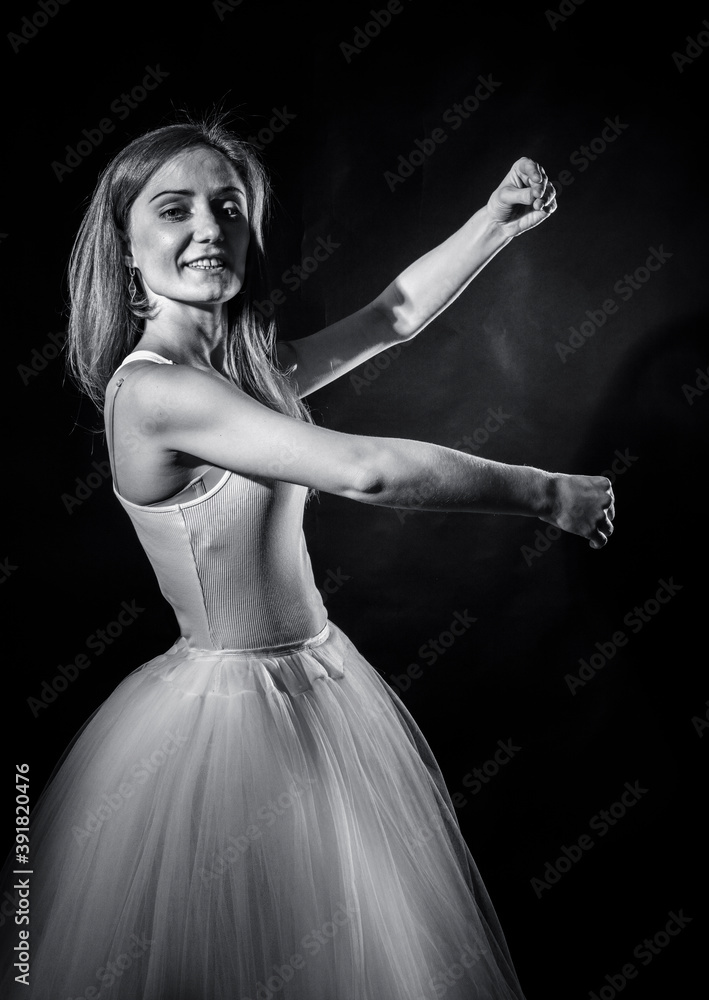 Fototapeta premium Young beautiful woman in a tutu studio portrait.