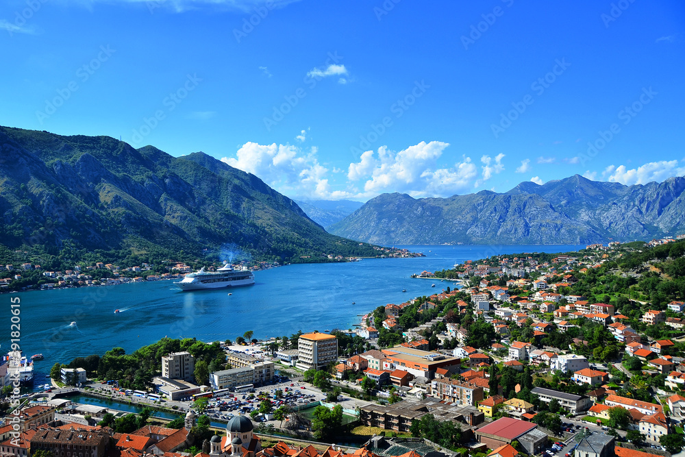 View of the Kotor bay blue summer sea old city and Montenegro mountains. Panorama mediterranean town