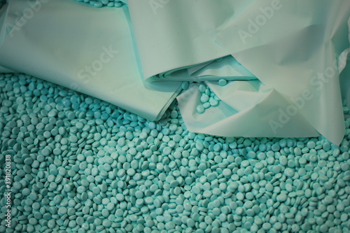 turquoise plastic polymer granules as background photo