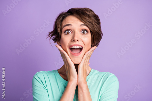 Close up photo of astonished young person open mouth arms on chin wear teal isolated on purple color background