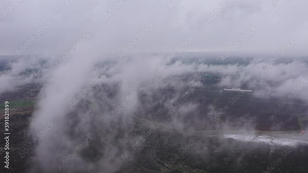 Aerial view of foggy landscape of lake, hills, and forests at the sunset in winter. Aerial view of foggy landscape of lake, hills, and forests at the sunset in winter.