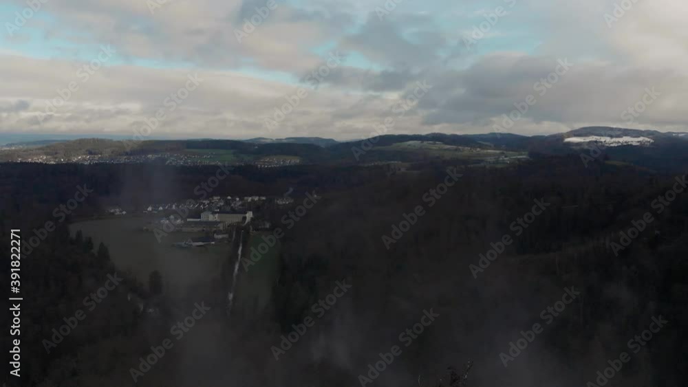 Aerial view of foggy landscape of lake, hills, and forests at the sunset in winter. Aerial view of foggy landscape of lake, hills, and forests at the sunset in winter.