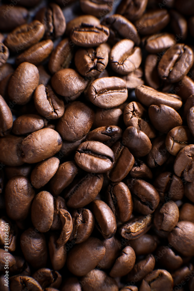 Coffee beans close up against the background of a coffee beans. Morning espresso. Coffee mug. Coffee beans close up against the background of a coffee beans. Morning espresso. Coffee mug.