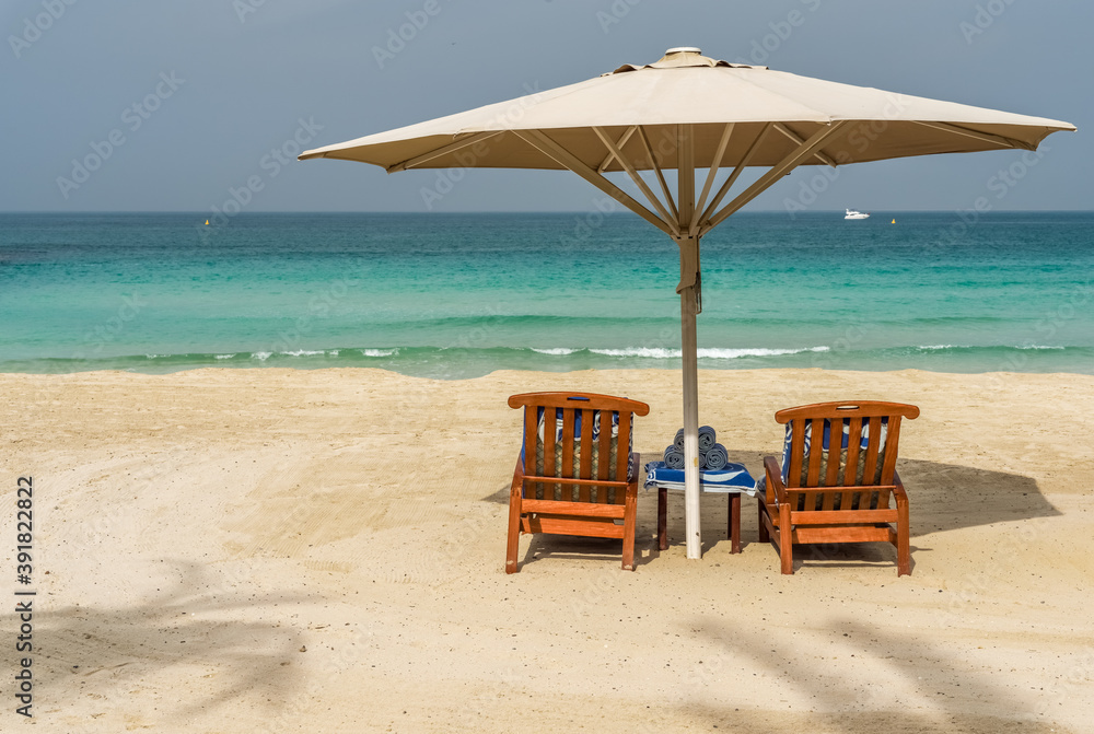 Beach chairs and  umbrella on a background of the sea