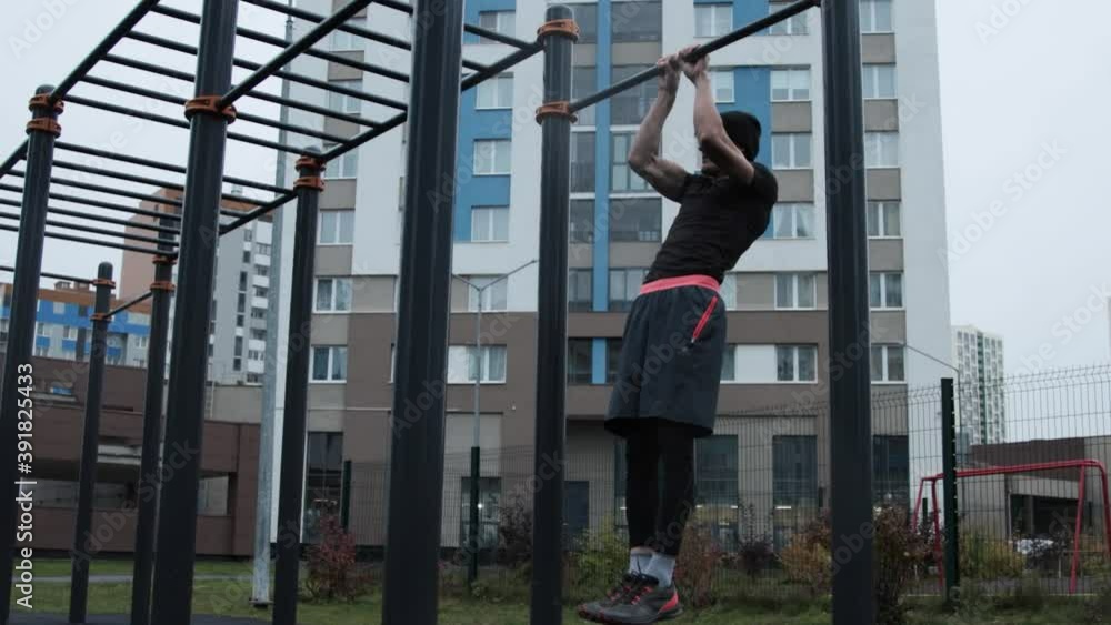 Muscular man training outdoors on sports field Muscular man training outdoors on sports field